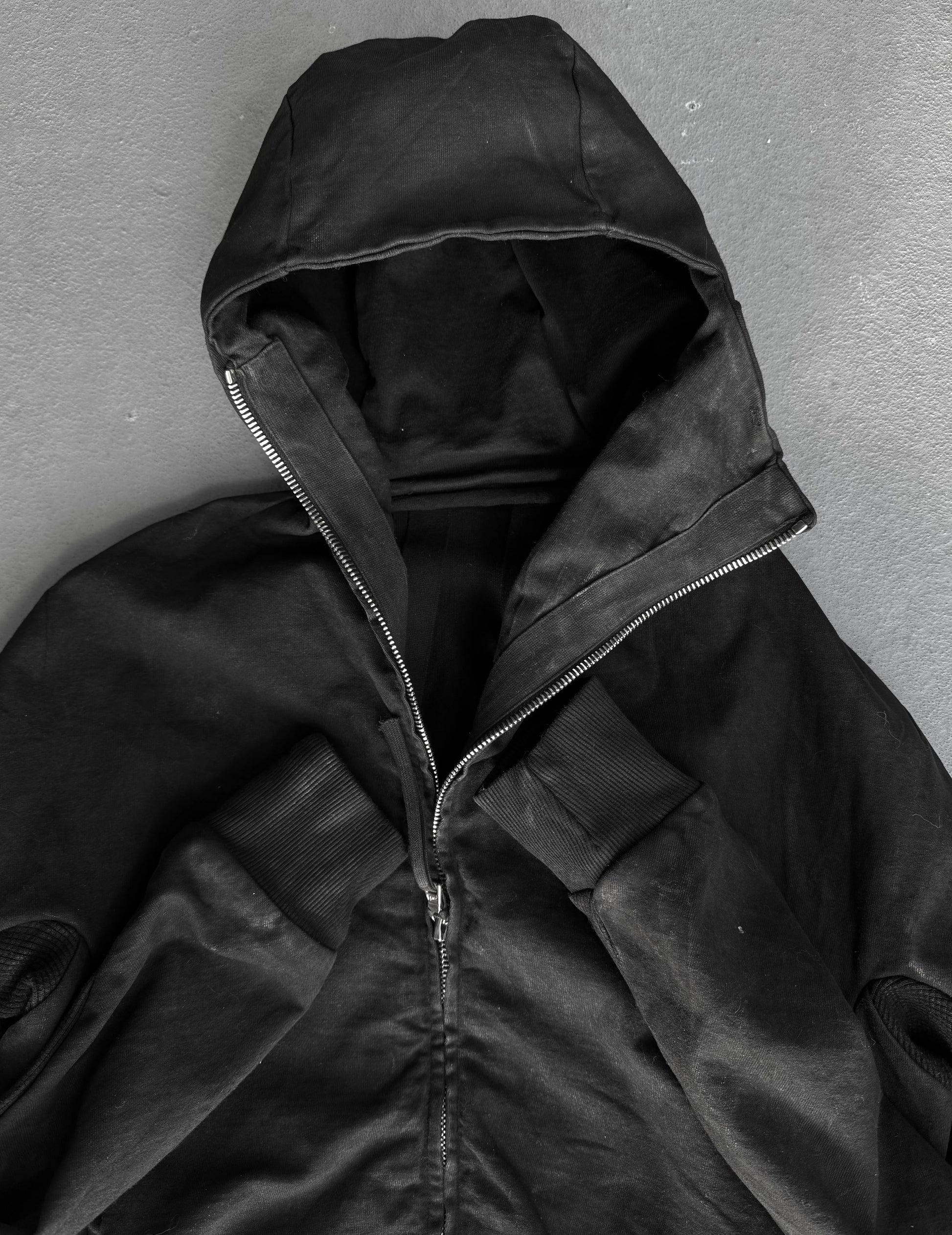 Black hooded jacket on a gray background