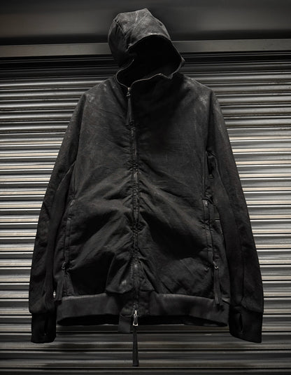 Black jacket with a hood on a metallic surface