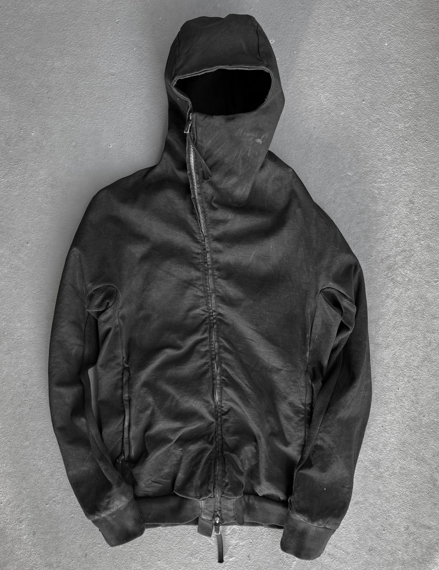 Black hooded jacket on a gray background