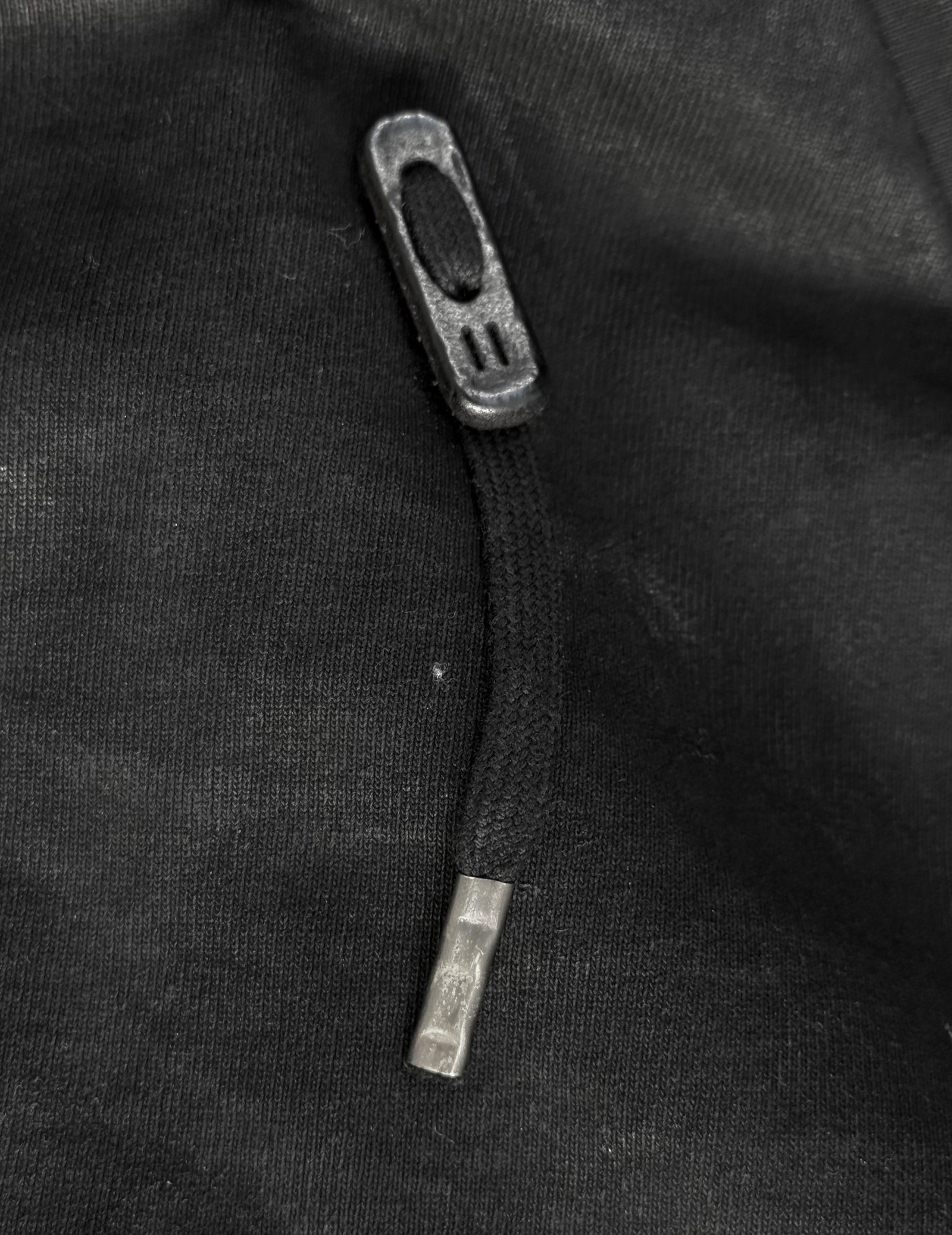 Close-up of a zipper on a black fabric background