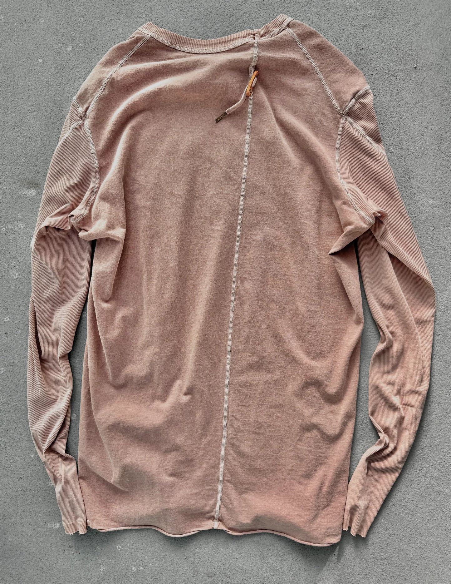 Pink long-sleeve shirt on a gray background