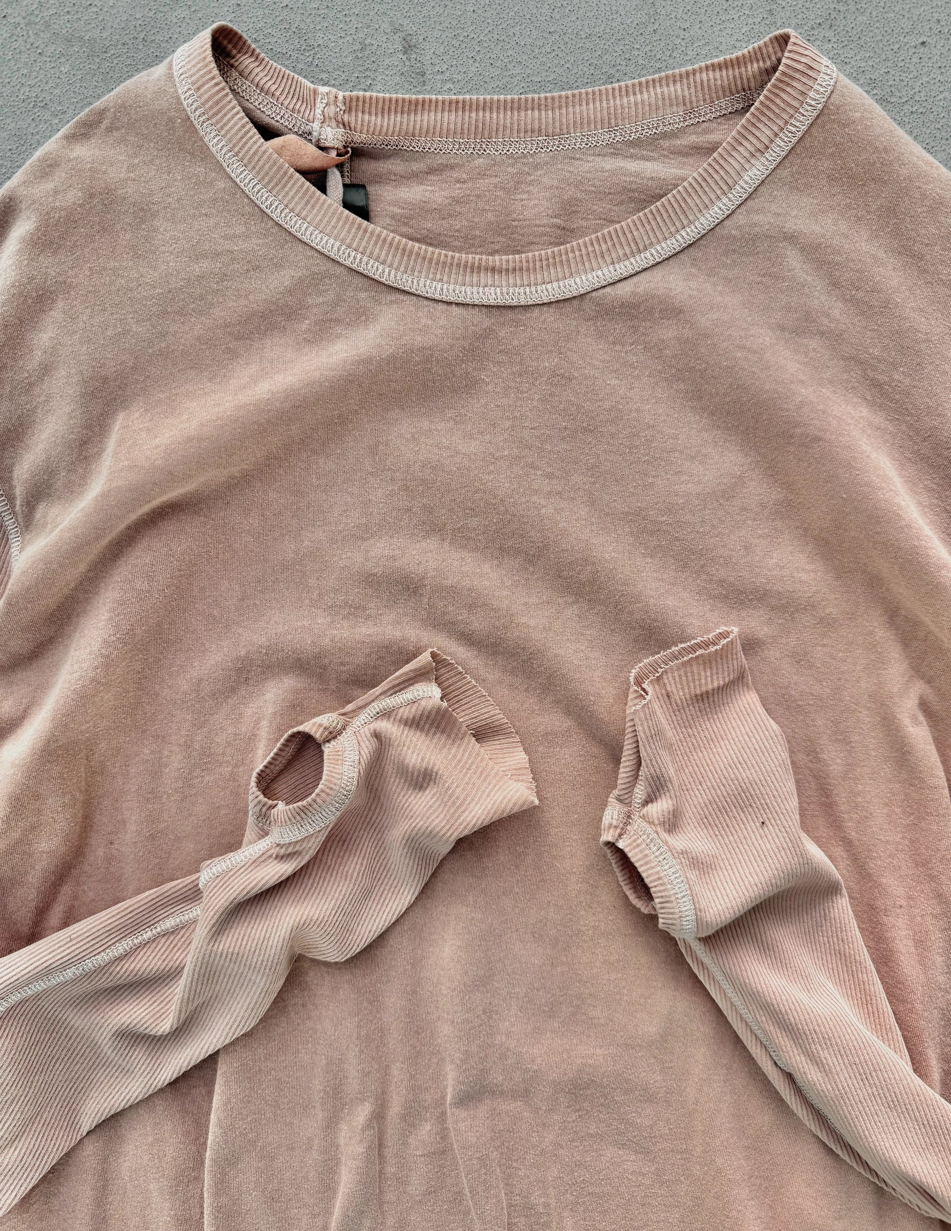 Brown ribbed sweater with a pocket on a gray background