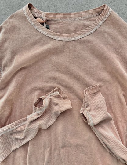 Brown ribbed sweater with a pocket on a gray background