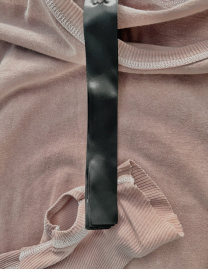 Black belt on a pinkish-brown fabric background