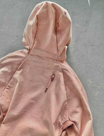 Pink hoodie on a gray surface