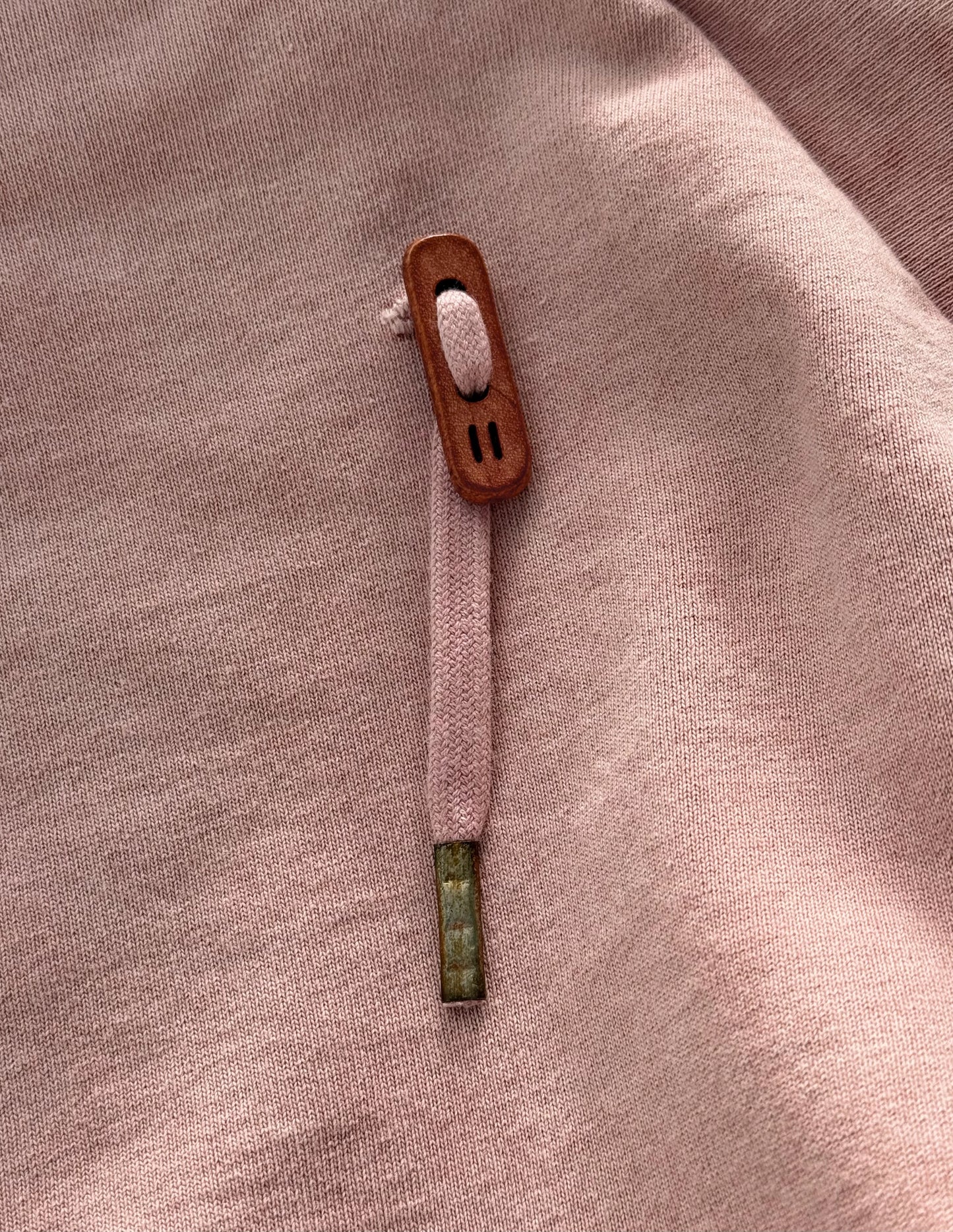 Close-up of a button on a pink fabric background