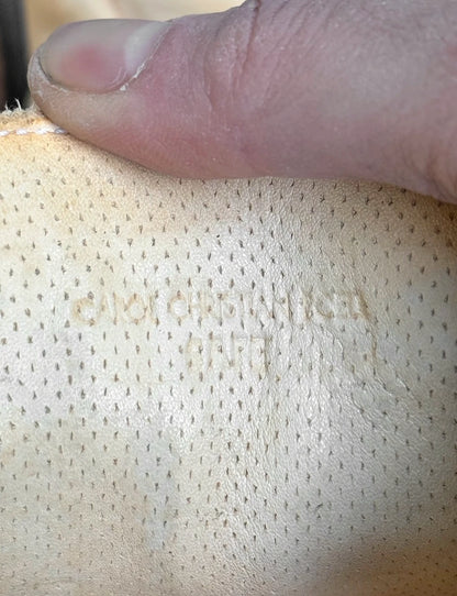 Close-up of a textured surface with a hand pressing down on it
