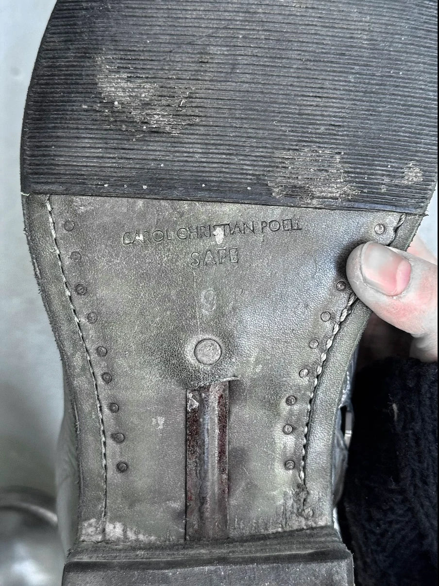 Close-up of a worn shoe sole with visible ‘CCP’ branding and wear.