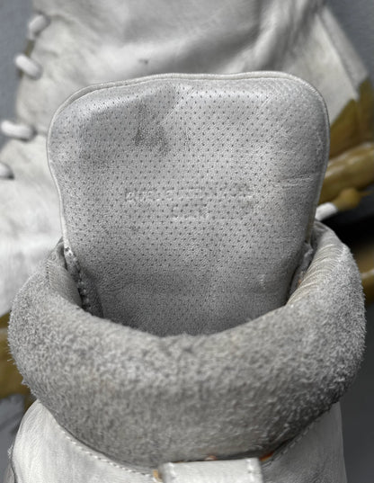 Close-up of a textured gray neck pillow with a blurred background