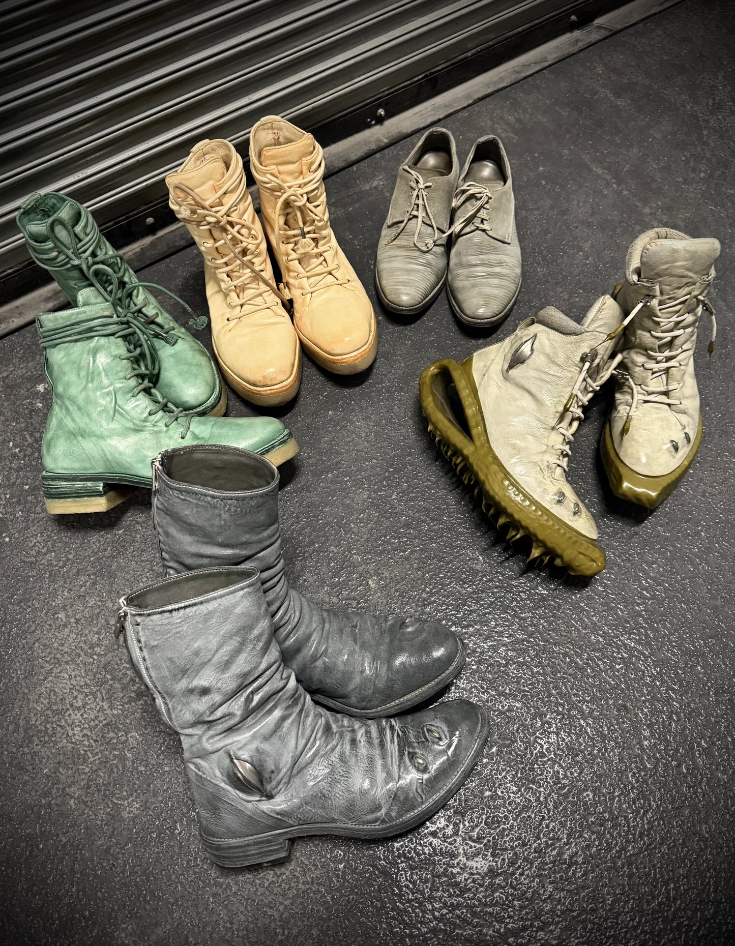 Collection of various boots on a dark surface