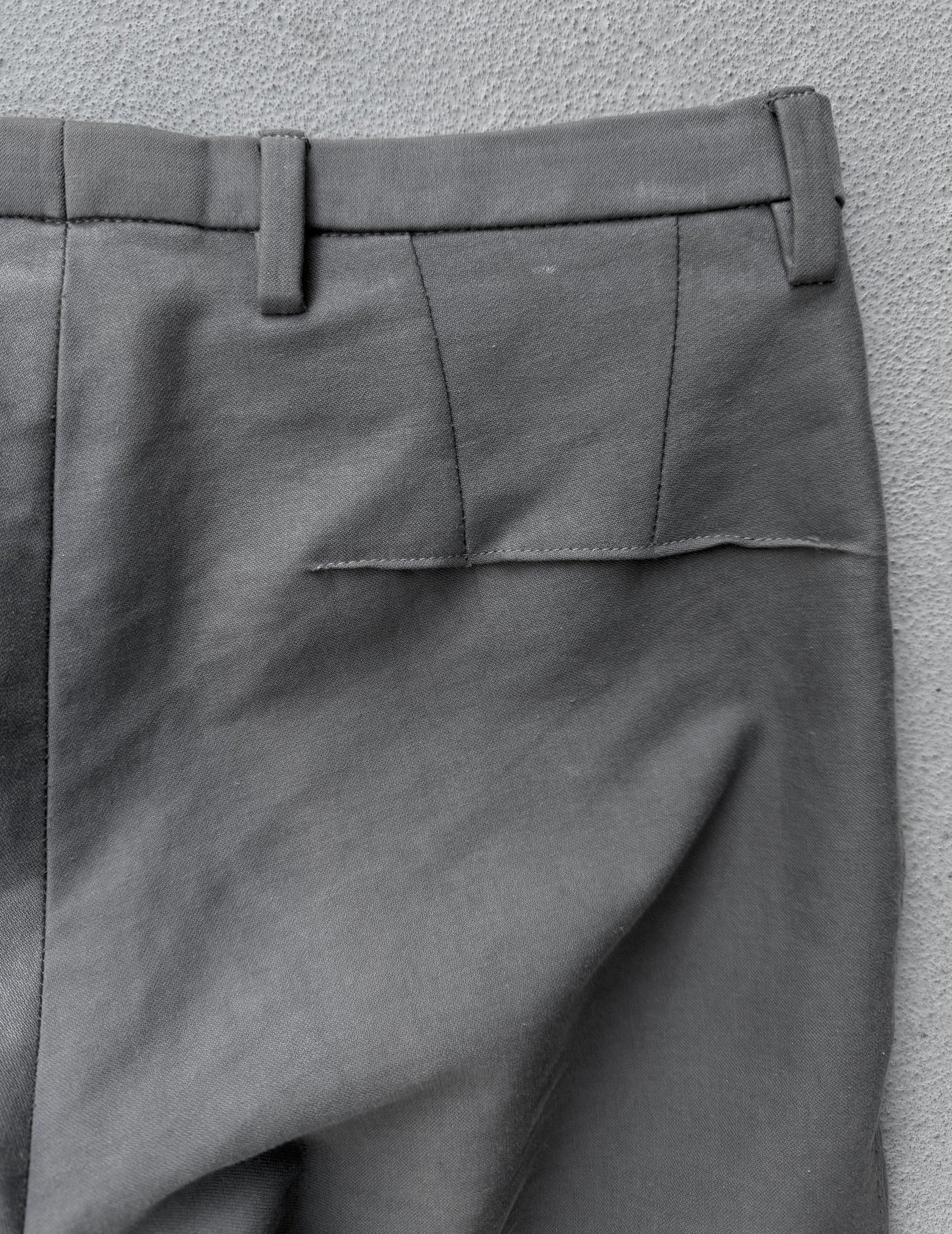 Gray pants with a pocket detail on a gray background