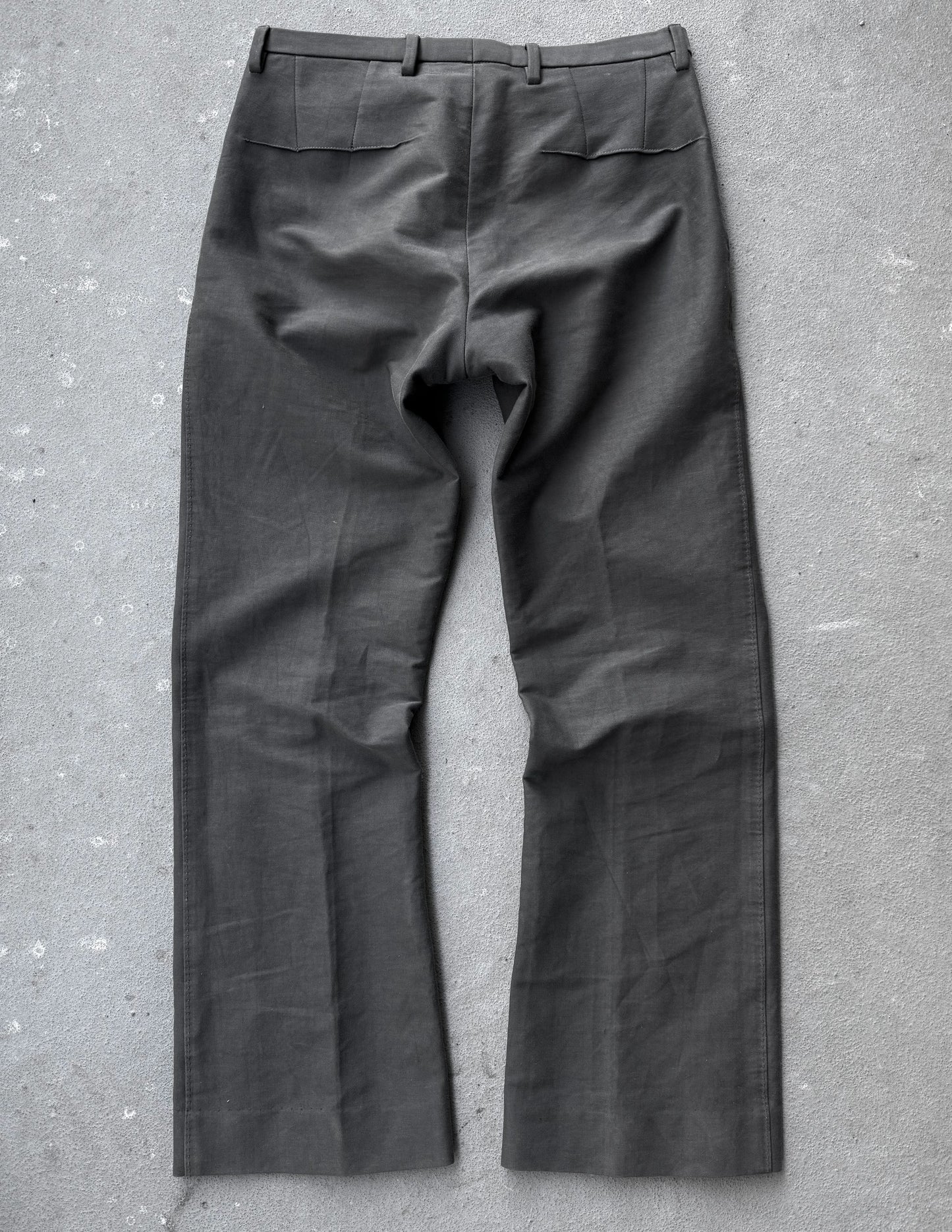 Dark gray pants on a textured gray surface