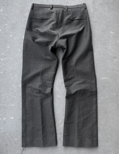 Dark gray pants on a textured gray surface