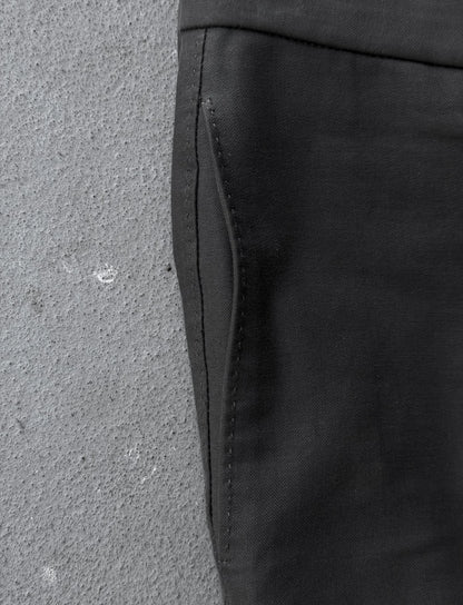 Close-up of a black fabric edge on a textured gray surface