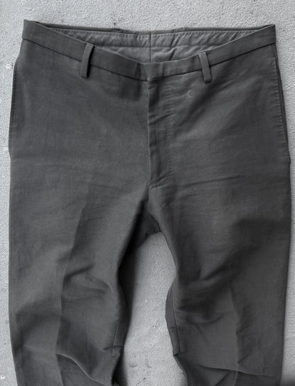 Dark gray pants on a textured gray surface