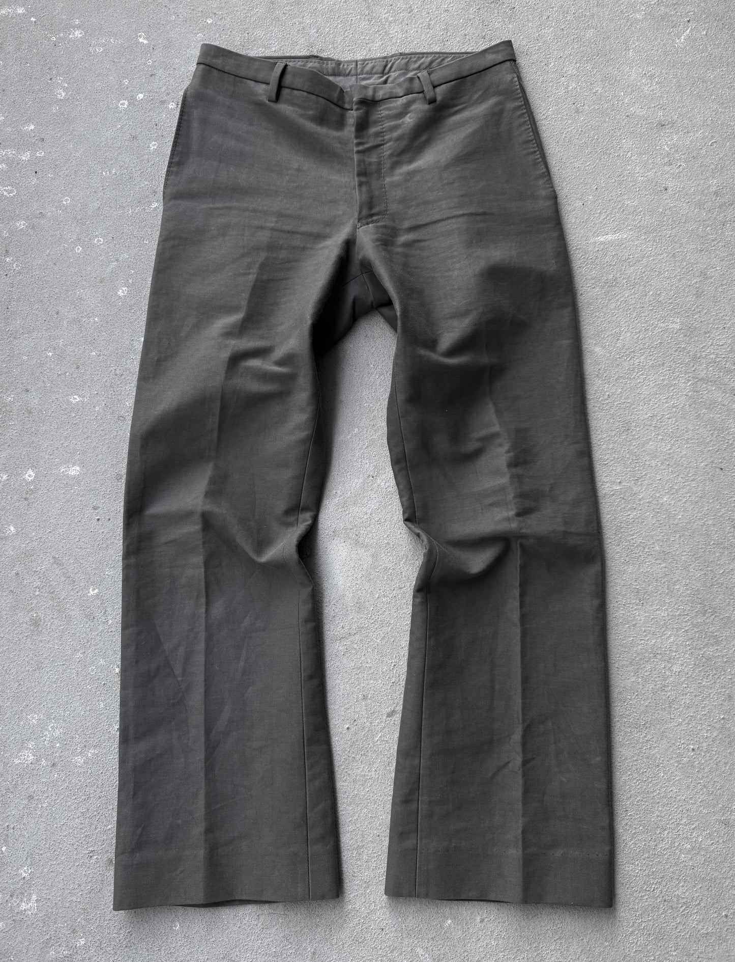 Dark gray pants on a textured gray surface