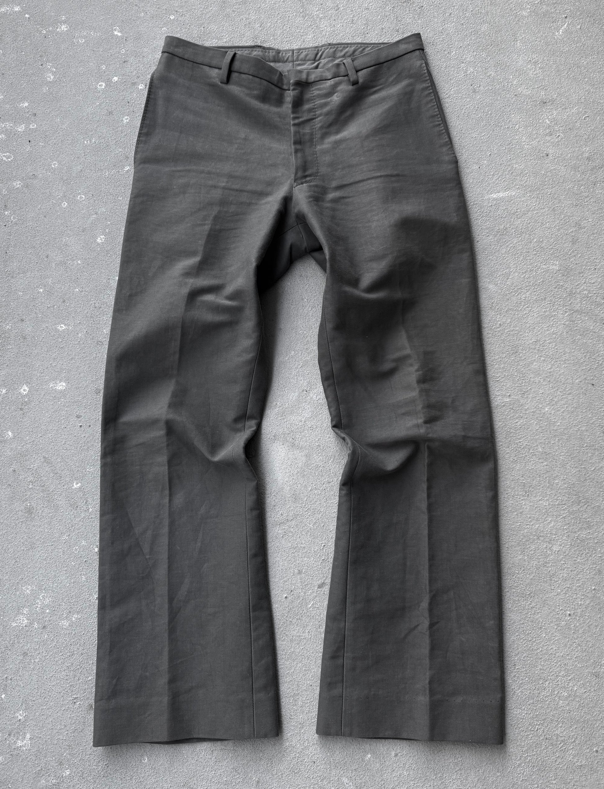 Dark gray pants on a textured gray surface