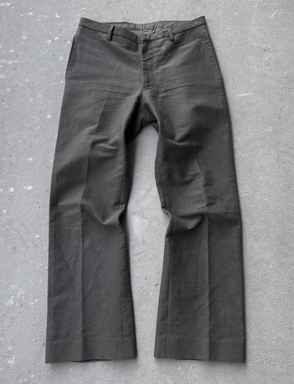 Dark gray pants on a textured gray surface