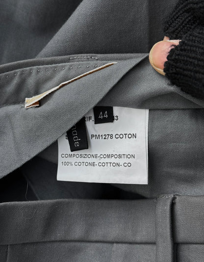 Close-up of a gray suit with a brand label on a dark background