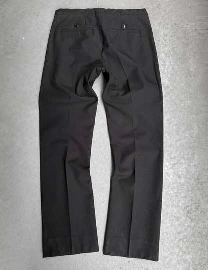 Black pants on a gray concrete surface