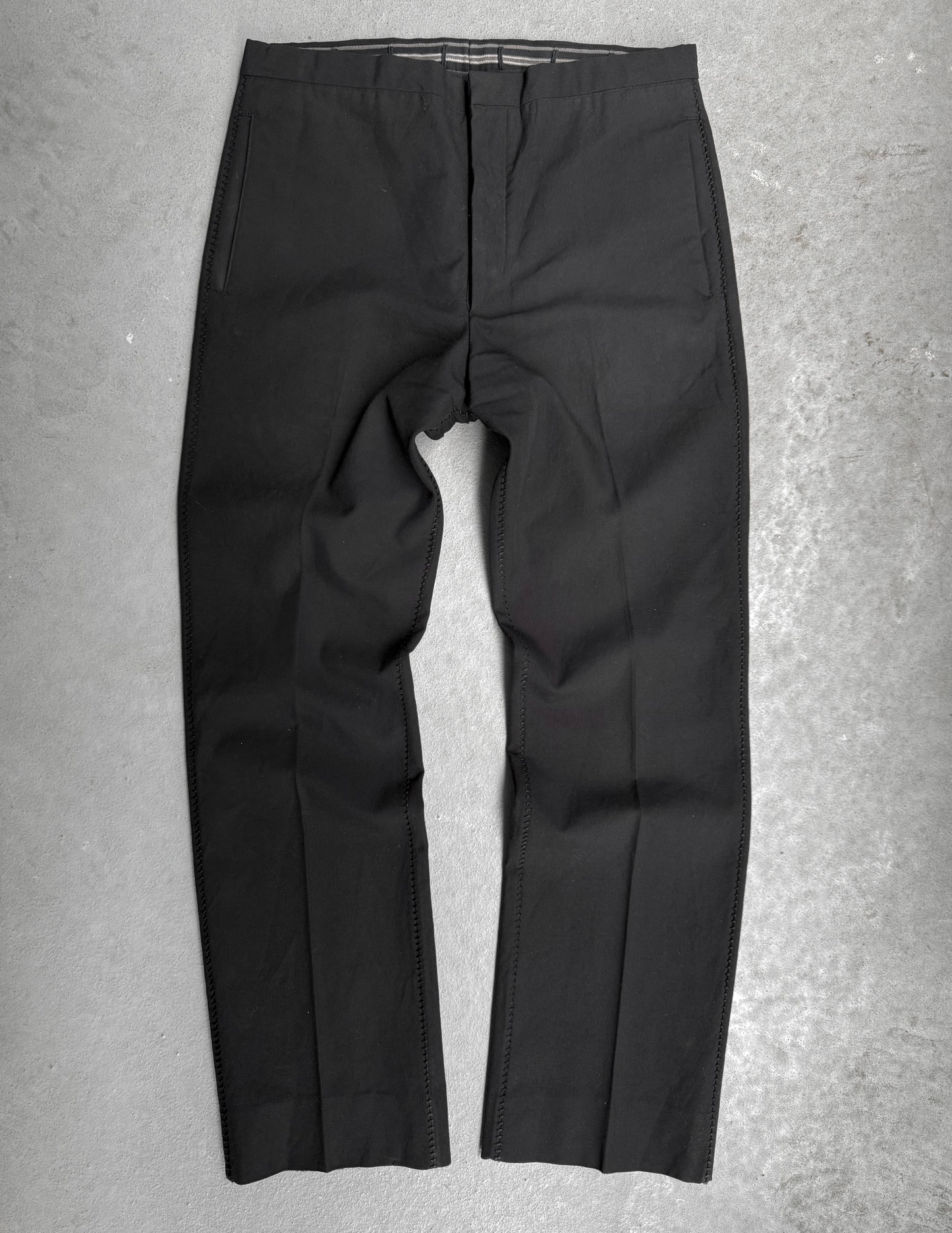 Black pants on a gray textured background