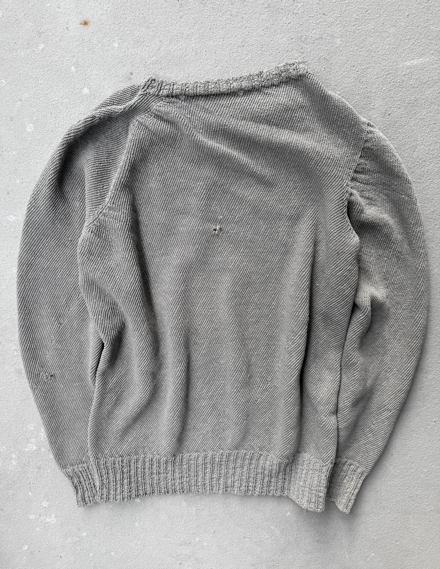 Gray sweater on a gray surface