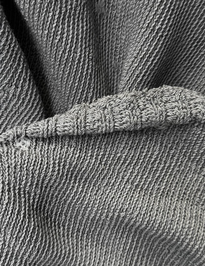 Close-up of gray textured fabric with a button