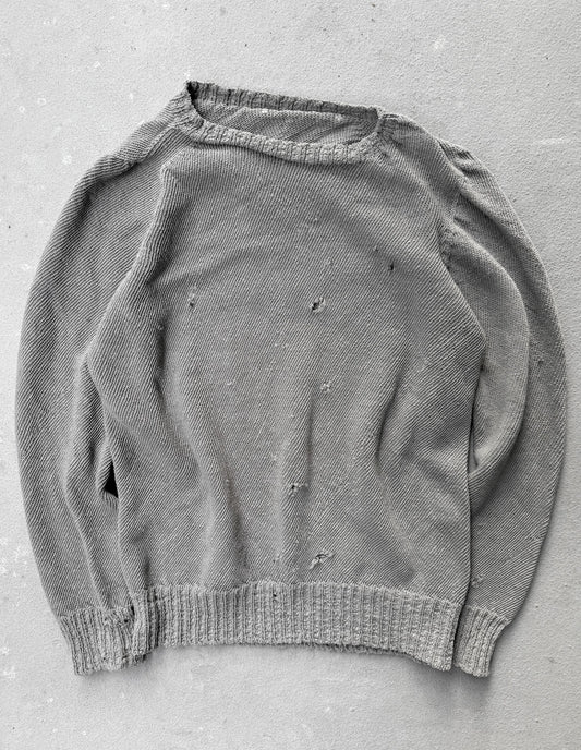 Gray sweater with visible wear on a gray background