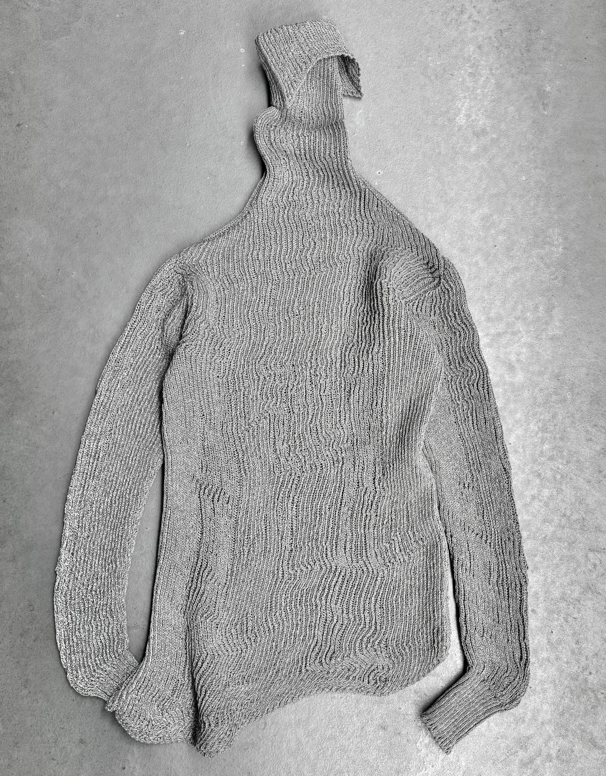 Gray knitted sweater on a gray background