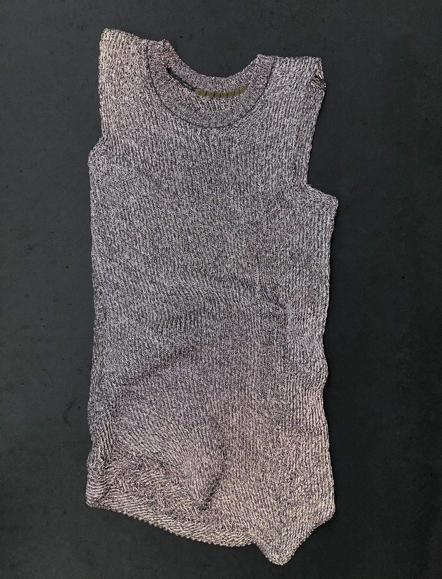 Knitted sleeveless romper on a dark background