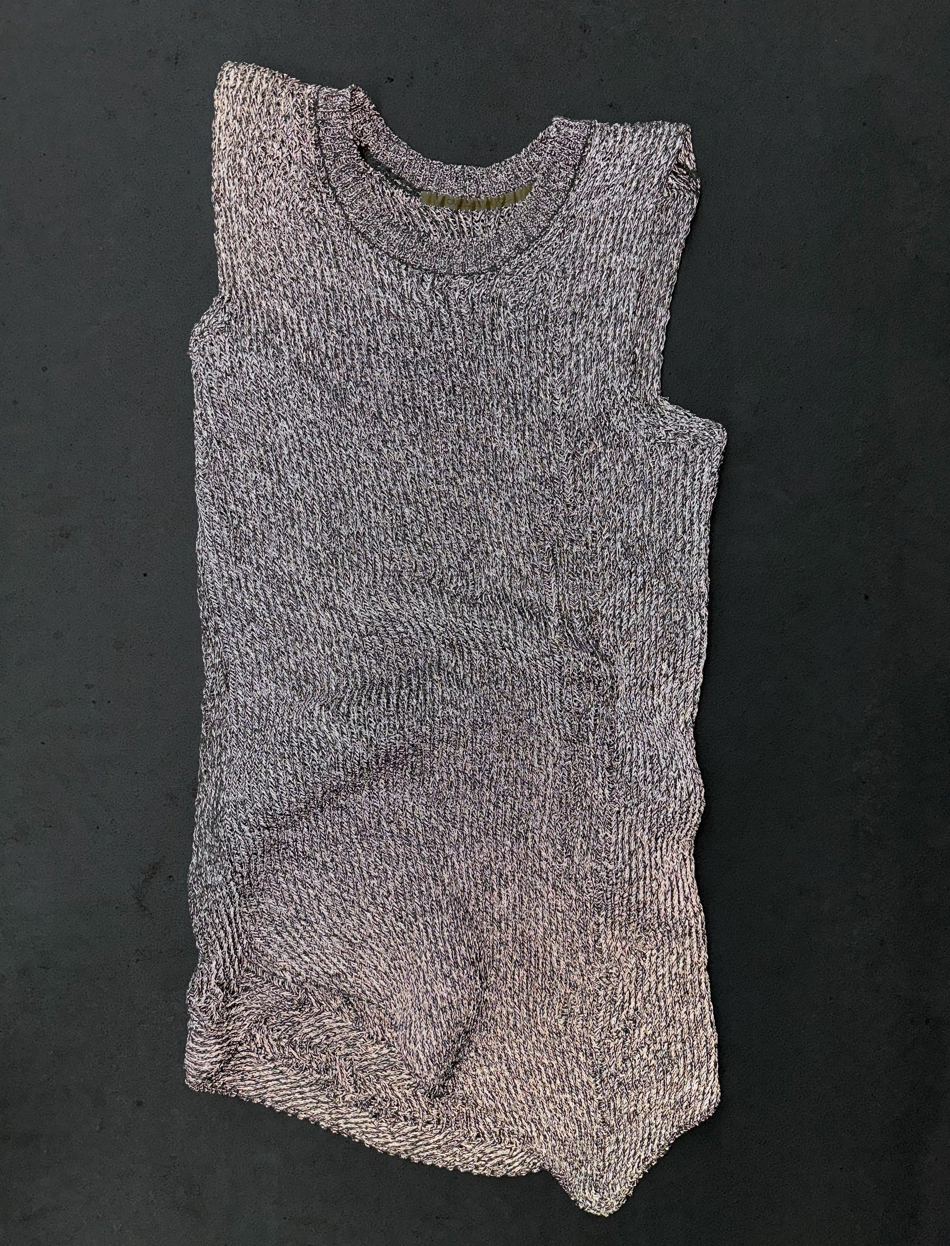 Knitted sleeveless romper on a dark background