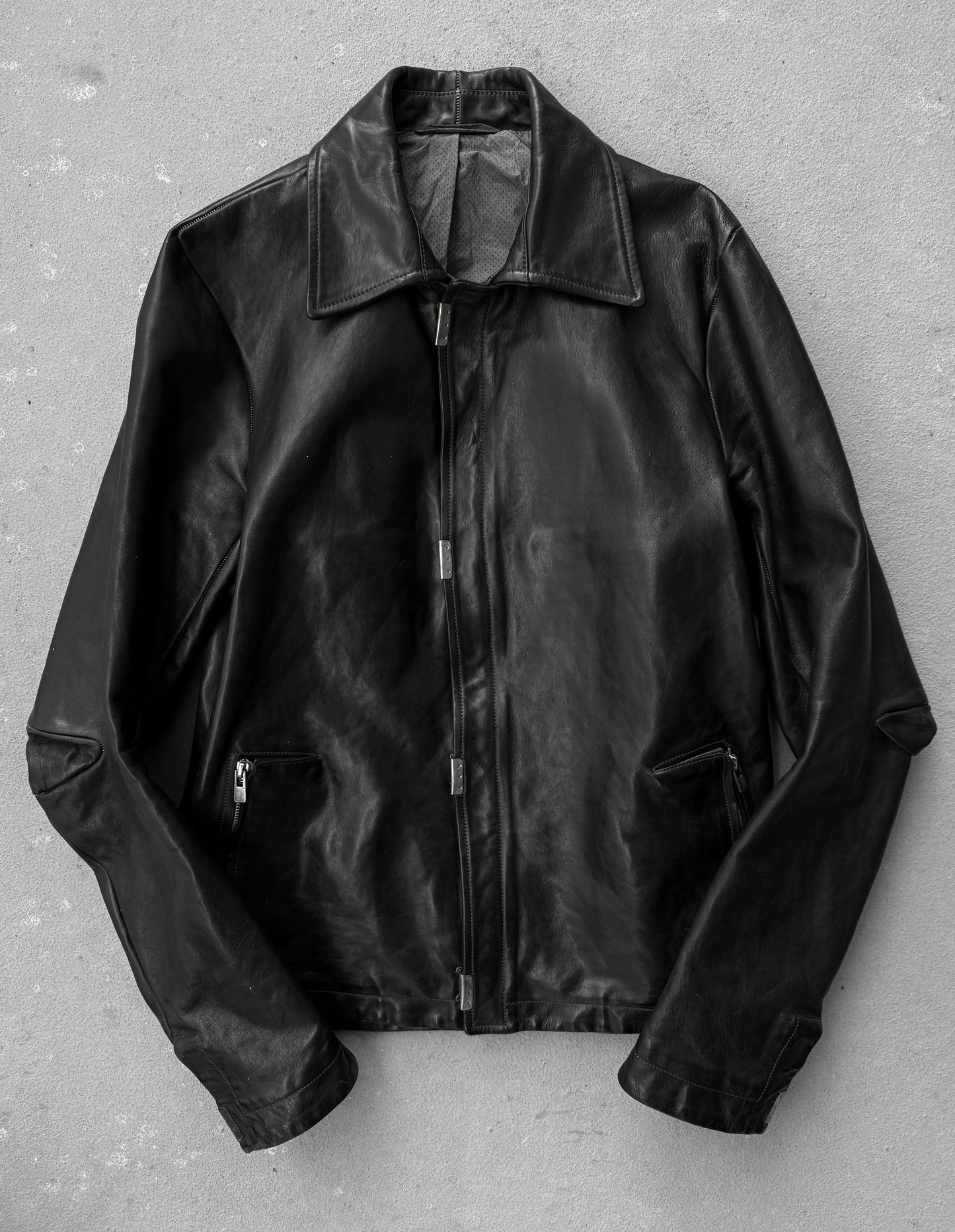 Black leather jacket on a gray background