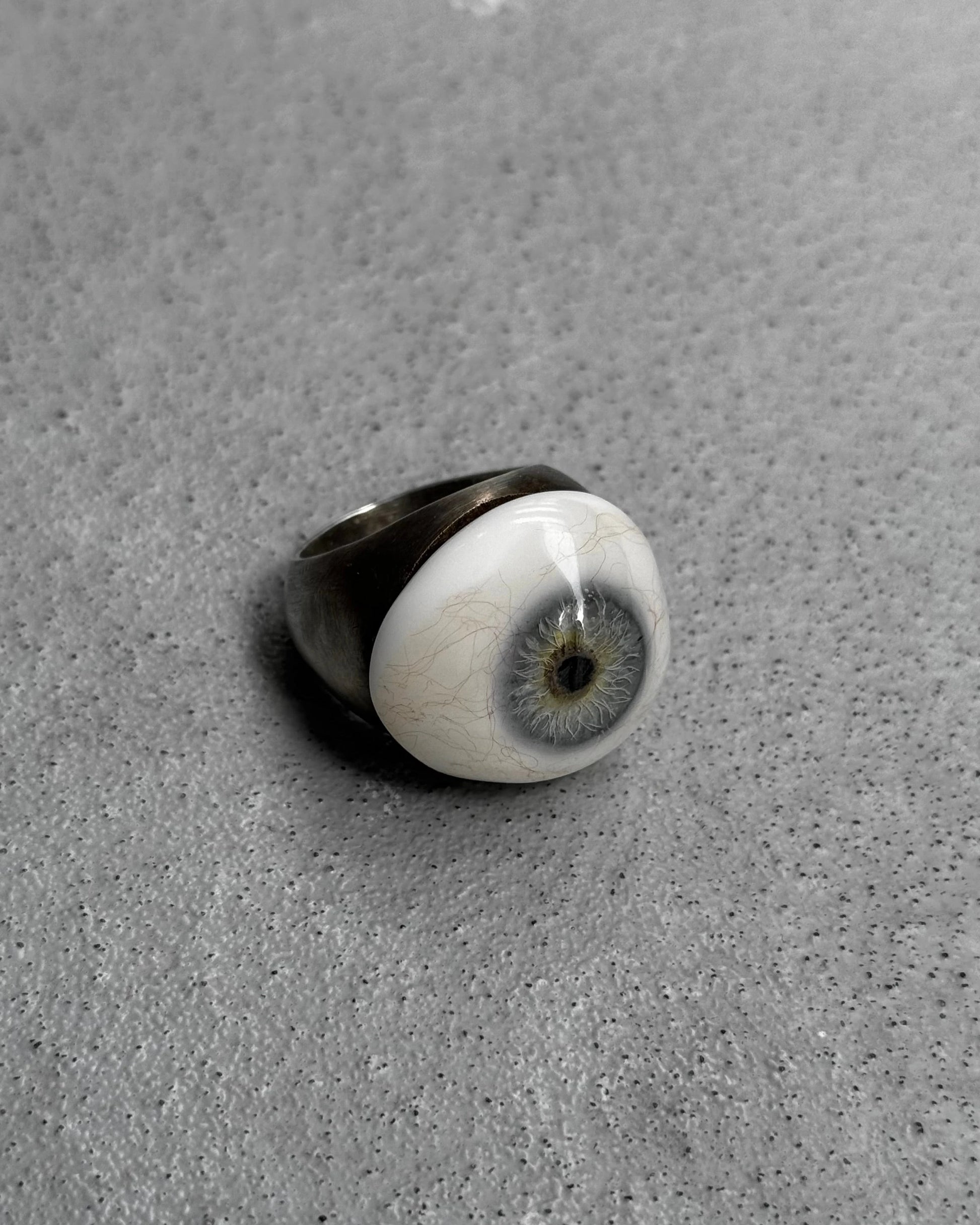Ring with a unique design on a gray surface
