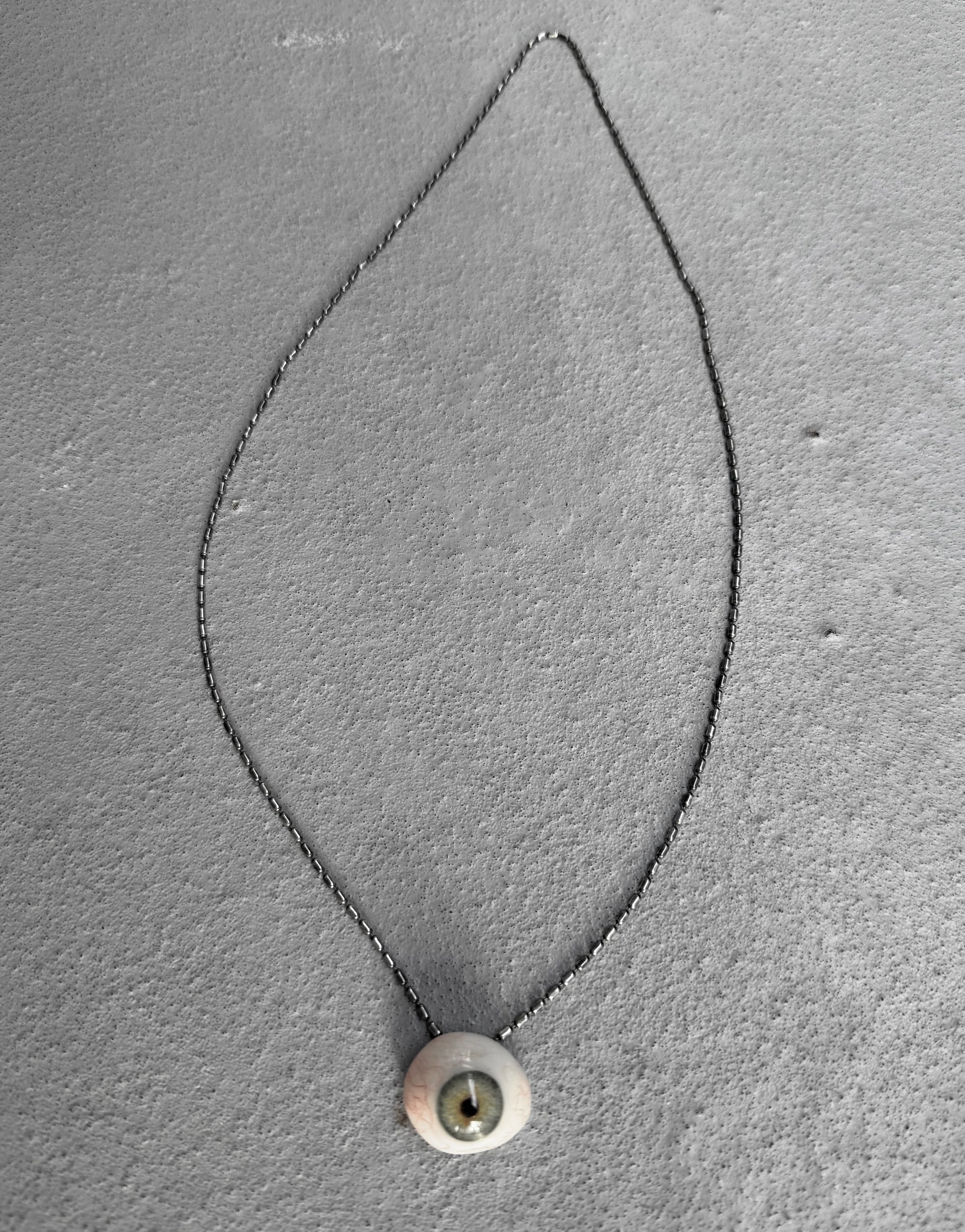 Necklace with a pendant on a gray textured background