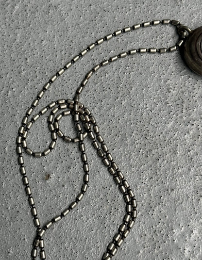 Close-up of a necklace with beads on a textured surface
