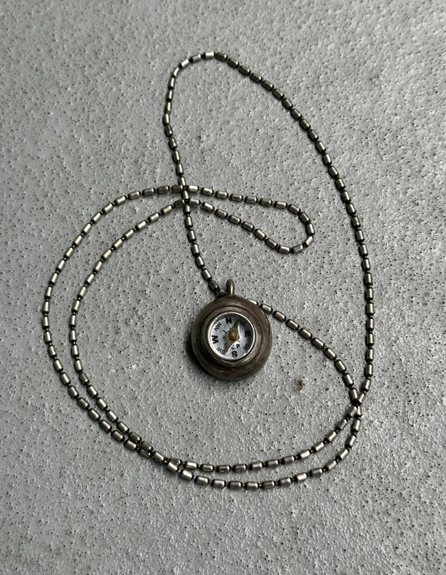 Necklace with a pendant on a textured surface