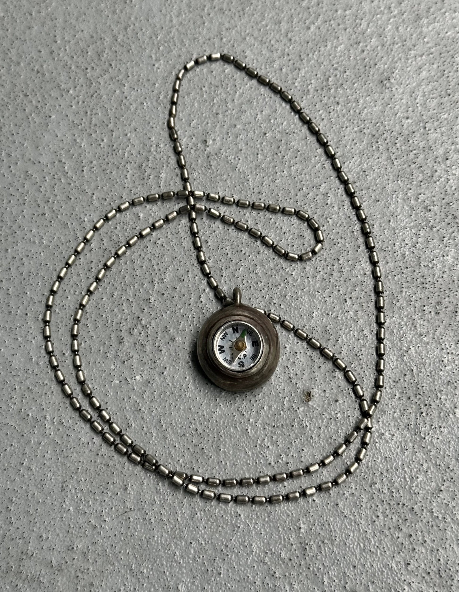 Necklace with a pendant on a textured surface