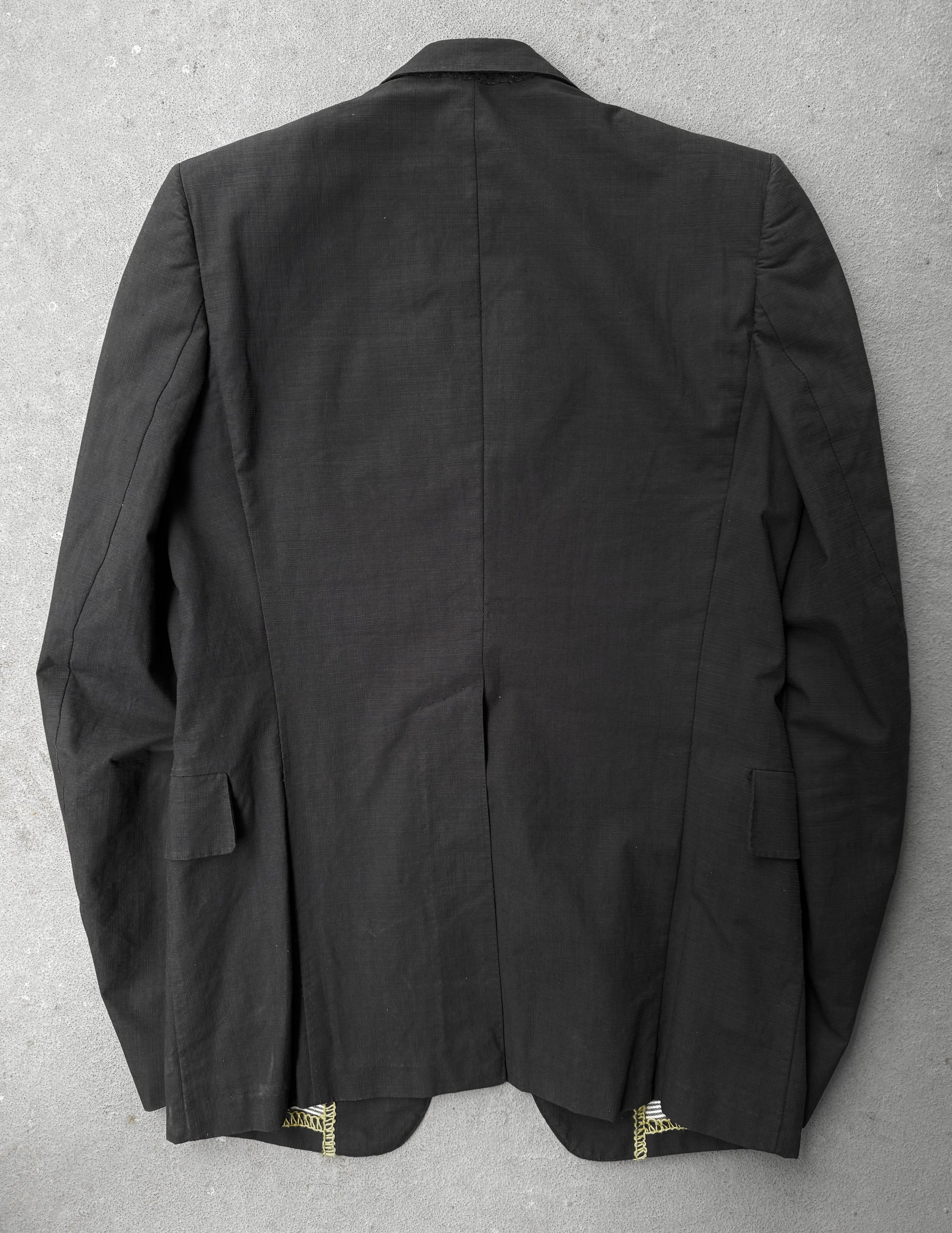 Black jacket with gold buttons on a gray background