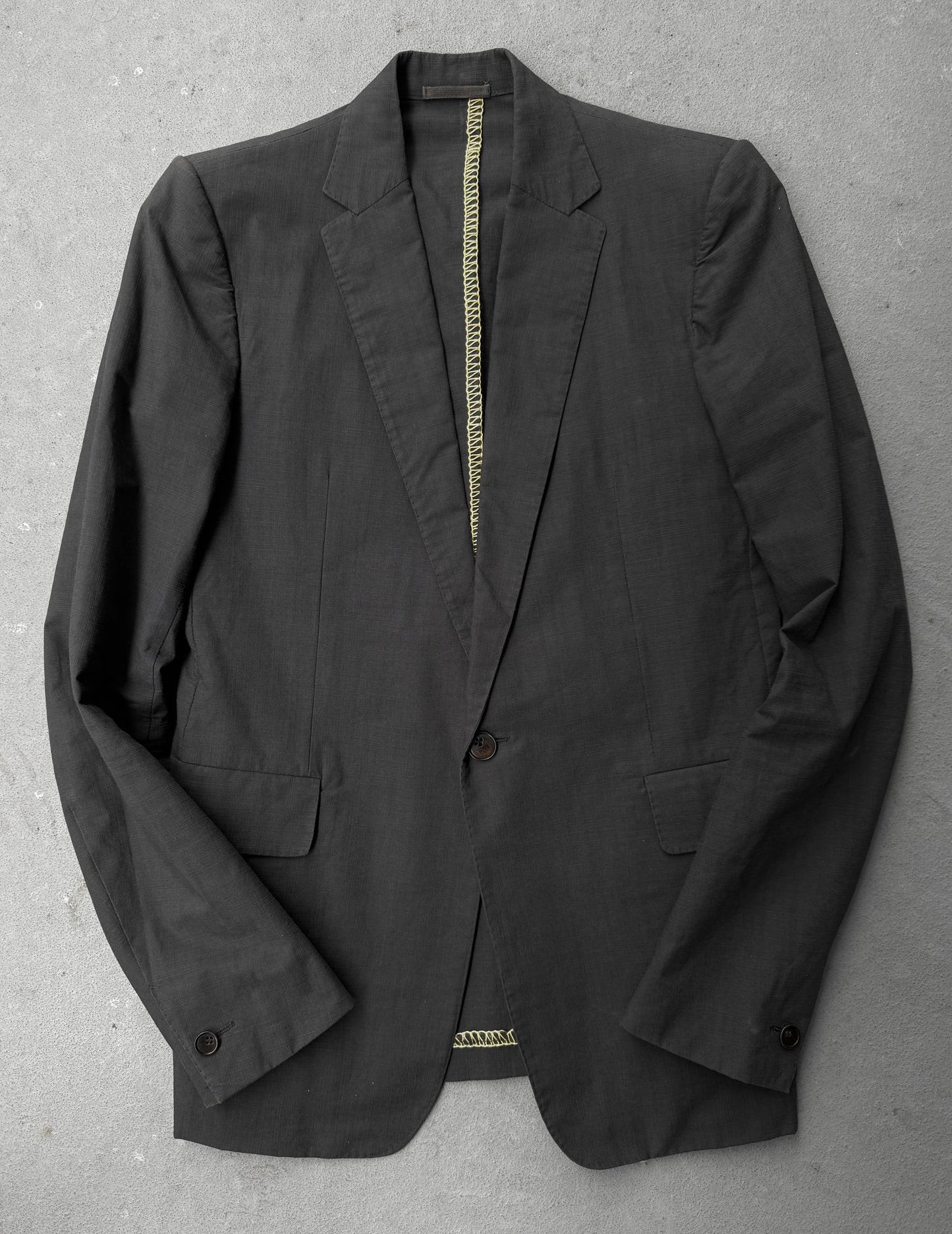 Black blazer on a gray surface
