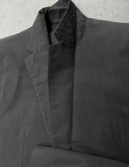 Dark gray coat with textured collar on a light gray background