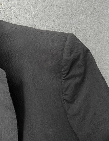 Dark gray fabric with a textured surface on a light gray background