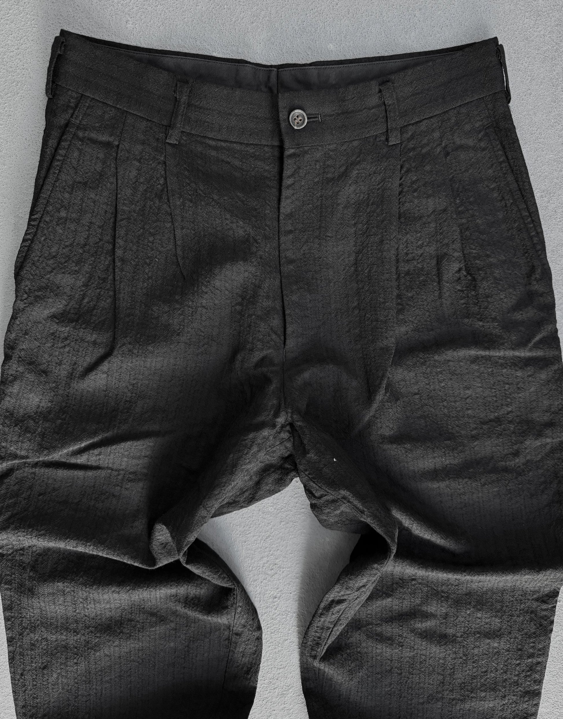 Dark gray pants on a light gray background