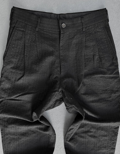 Dark gray pants on a light gray background