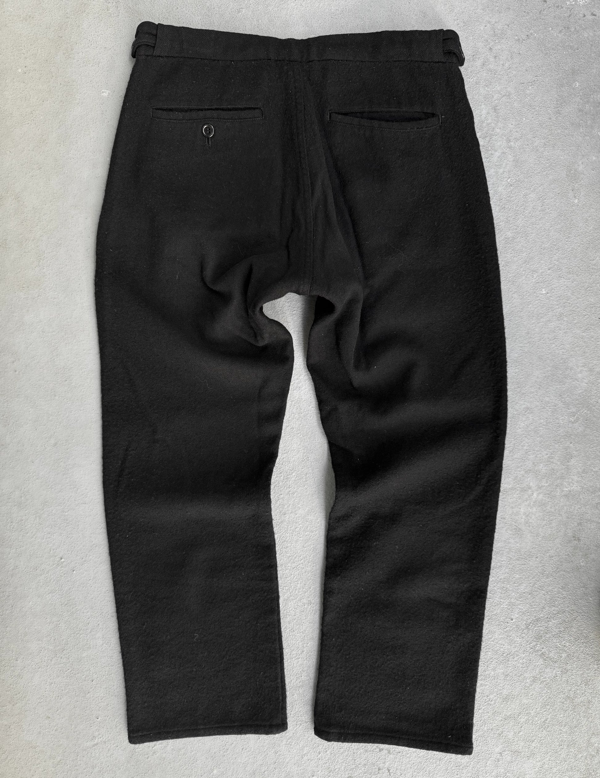 Black pants on a textured gray background