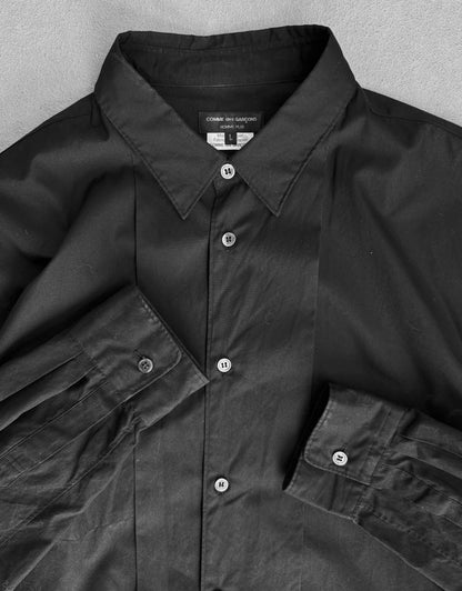 Black shirt with collar and buttons on a gray background
