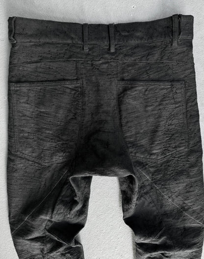 Dark gray pants on a white stand against a light gray background