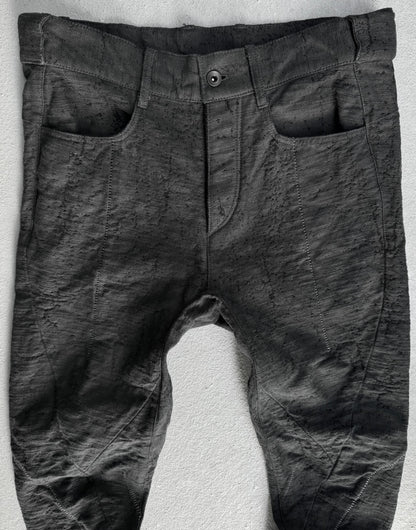 Dark gray pants on a textured white surface