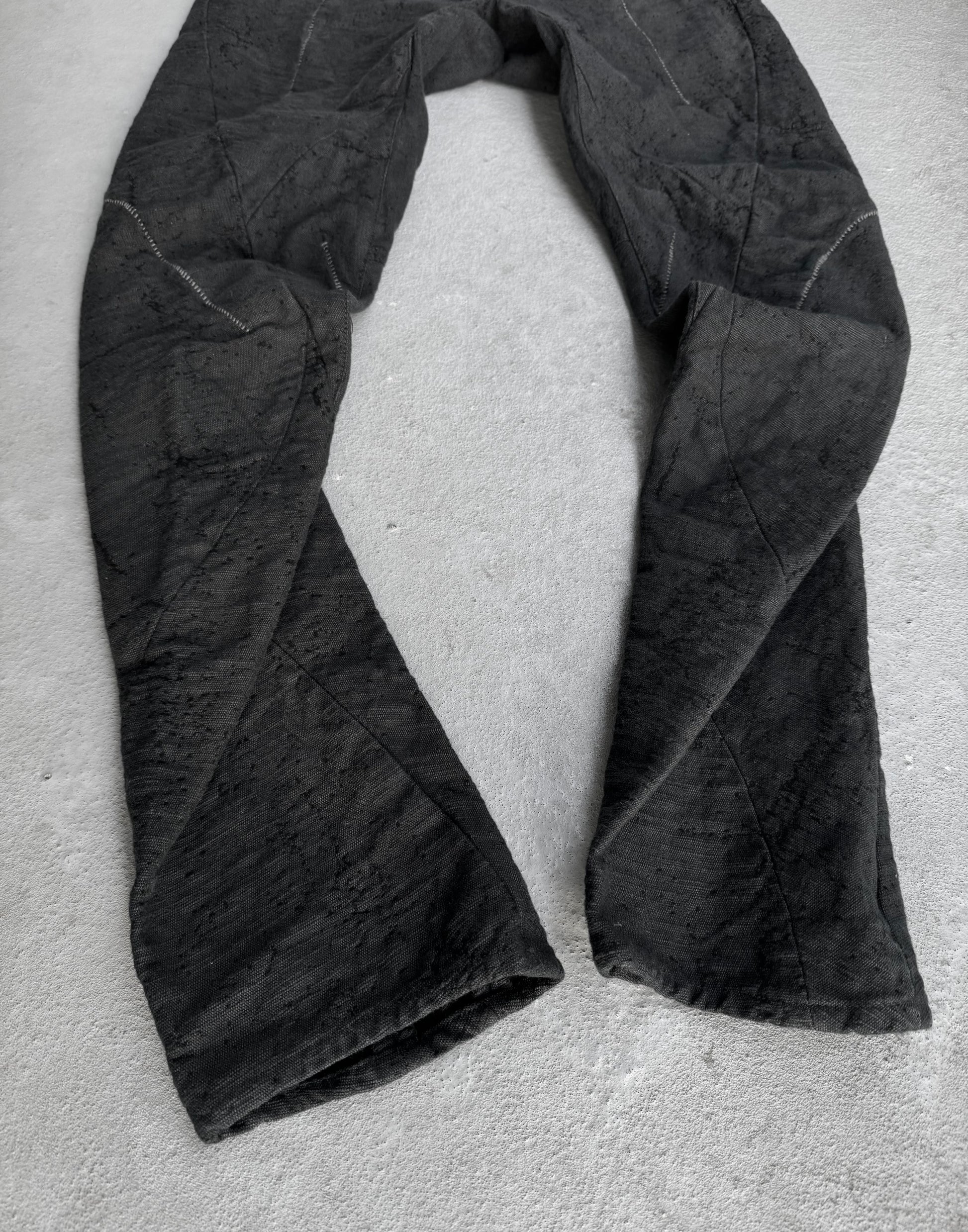 Black fabric draped over a light gray surface