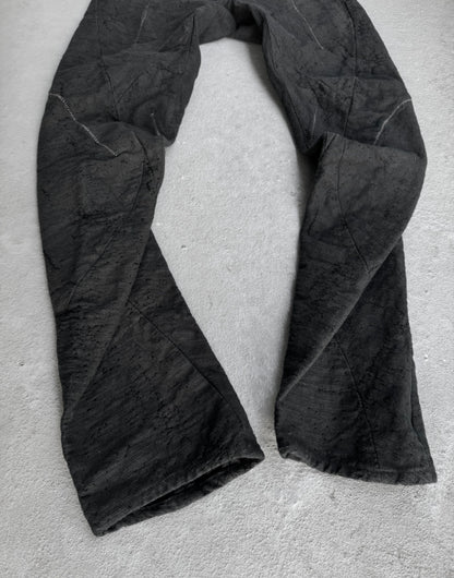 Black fabric draped over a light gray surface