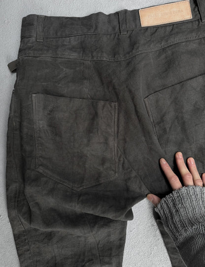 Dark gray pants with a brand label on a light gray background